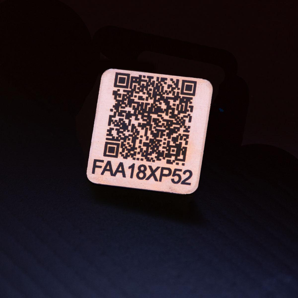 Drone tag made from copper and laser engraved with FAA registration number.